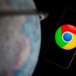 Google Chrome on smartphone next to globe stock photo